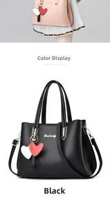 Detailed view of textured lychee grain leather handbags with heart-shaped charms