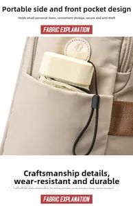 Detail of durable beige backpack front pocket featuring a compact umbrella for scale