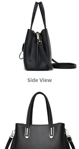 Macro view of black lychee grain leather handbag with premium gold-tone metal hardware