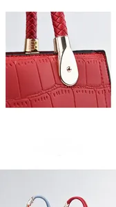 Close-up of red crocodile embossed leather with woven handle and gold hardware detail