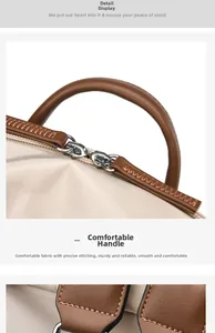 Close-up of precise stitching on cream backpack with comfortable brown leather handle