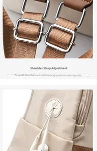 Detail of adjustable brown shoulder strap with metal buckle and headphone jack on beige backpack