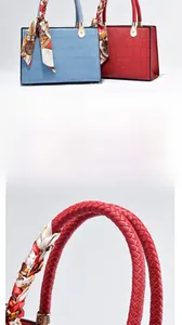 Detail of crocodile embossed leather handbag with woven handle and colorful silk scarf