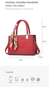 Detail view of red crocodile pattern handbag with silk scarf and dimensions 25x10x17cm