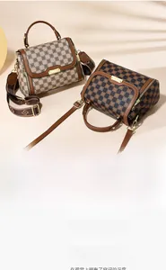 Detail of vintage plaid texture and metallic buckle on women's crossbody bag