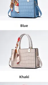 Detail of blue and khaki croc-effect handbags with silk scarf and braided handles
