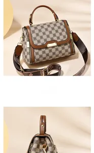 Close-up of a retro checkered handbag with premium brown leather handle and wide strap