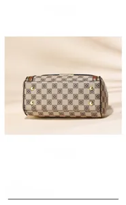 Detail view of the checkered barrel bag base with protective gold-tone metal studs
