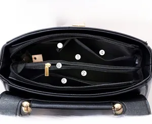 Interior detail of handbag featuring six functional compartments for organized storage
