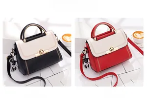 Detail view of contrast PU leather handbags with metal ring clasps and bear charms