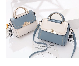 Detail of color-block handbags with metal handles, contrast stitching and bear charm