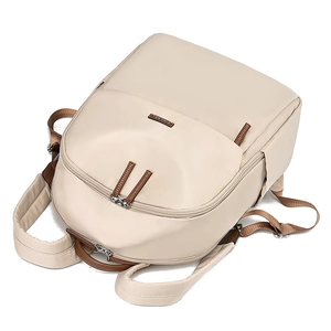 Lightweight beige nylon backpack with multiple zipper pockets for travel and school