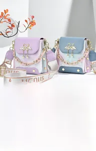 Detail of mini crossbody bags with floral pattern and golden swan heart metal buckle