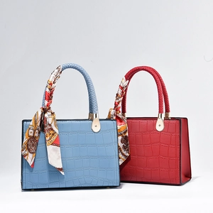 Elegant crocodile pattern handbags in red and blue with silk scarf wrapped handles