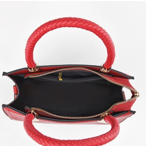Red crocodile embossed handbag with woven handle and gold zipper top view