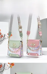 Close-up of stylish mini crossbody bag featuring swan metal buckle and resin chain detail