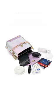 Detail view of mini crossbody bag interior showing large capacity for phone and cosmetics
