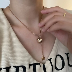 Rose gold double-layer necklace with heart and star pendants on polished titanium steel