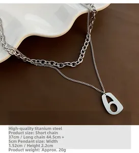 Detail view of double-layer titanium steel necklace with snake chain and hollow pendant