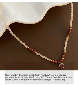 Close-up of natural stone beaded necklace with pink stones and red square pendant