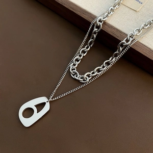 Double-layered silver stainless steel chain with a geometric pendant on brown leather