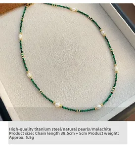 Detail of malachite and freshwater pearl necklace with 18k gold-plated steel beads