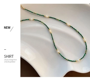 Detail of malachite and freshwater pearl necklace with adjustable gold-plated chain