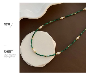 Detail of vintage style necklace with malachite beads, freshwater pearls and gold spacers