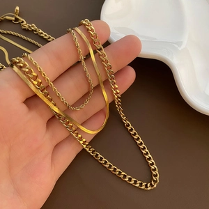 Three-layer gold stainless steel necklace set with snake, curb, and rope chains