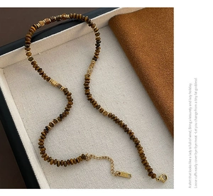 Tiger eye beaded necklace close-up showing gold lobster clasp and 925 silver extension chain