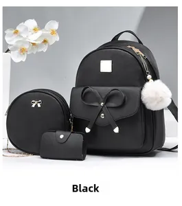 Three-piece black PU leather backpack set with gold bow details and plush ball charm
