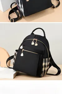Detail of oxford backpack featuring black fabric and grey plaid side pocket design