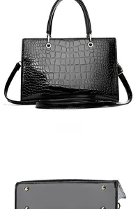 Détail de la texture arrière et des pieds en métal d'un sac à main noir motif crocodile