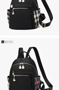 Detail of waterproof black nylon backpack featuring contrast plaid side pockets and gold zipper