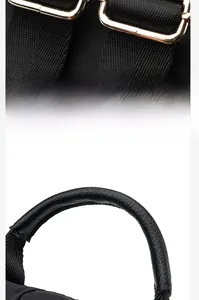 Detail of adjustable gold buckle and black textured leather handle on oxford backpack