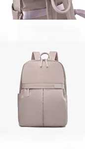 Detail view of the durable nylon fabric, zippers and side pockets on the purple backpack