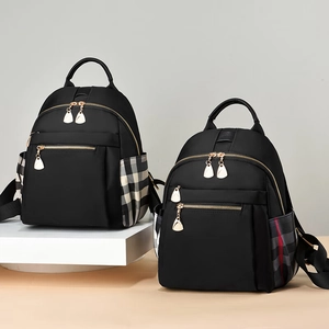 Stylish black nylon backpack for women featuring trendy plaid side pockets and gold zippers