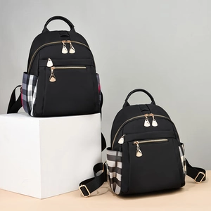 Women's black nylon backpack with elegant plaid side pockets and gold metal zippers