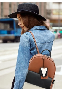 Sac à dos tendance color-block avec texture cuir porté par un mannequin à l'extérieur