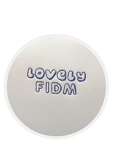 Macro shot of heavy embroidery detail with blue and white letters on a white leather bag