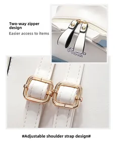 Detail of white leather backpack with golden double zippers and adjustable strap buckle