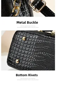 Close-up of golden metal buckle and protective bottom rivets on black embossed bucket bag
