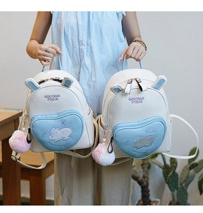 Detail of a mini rabbit backpack with heart-shaped pocket and cute bunny ears decoration