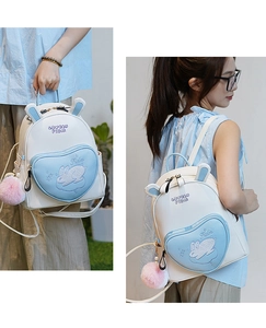 Close-up of mini rabbit backpack with 3D ears and blue heart-shaped zipper pocket