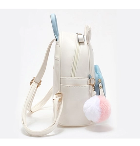 Close-up of white mini rabbit backpack with blue handles and plush pom-pom charm