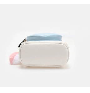 Detail view of mini backpack base in blue and white leather with plush charm