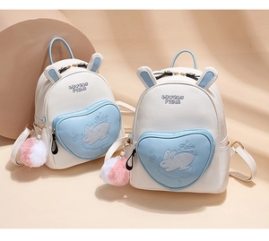 Detail view of cute rabbit ear backpacks with heart pockets and pearl chain decor