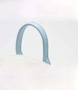 Close-up of the reinforced blue leather handle with premium stitching on a mini backpack