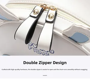 Macro shot of double metal zippers and blue FIDM embroidery on white leather backpack