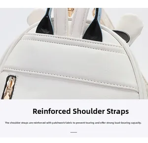 Close-up of white mini backpack showing reinforced tricolor straps and gold zipper details